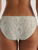 A model in the araks french lace tris panty in caledonia green