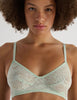 A model in the araks french lace tamara bralette in caledonia green