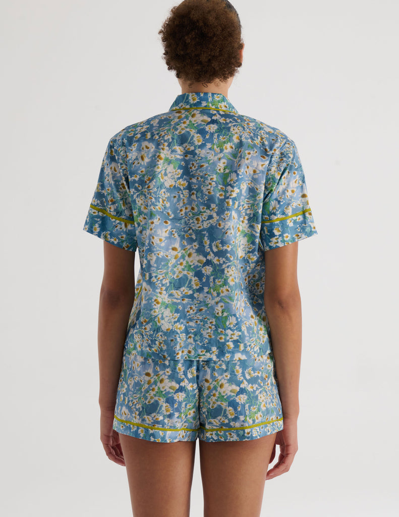 A model in the araks liberty of london tana lawn cotton shelby pajama top and tia boxer in daisy