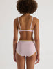 A model in the Araks organic cotton antonia bralette and mabel hipster in confection pink