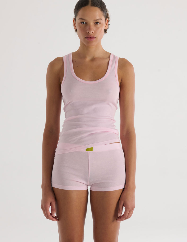 A model in the araks organic cotton james tank and presley short in confection pink