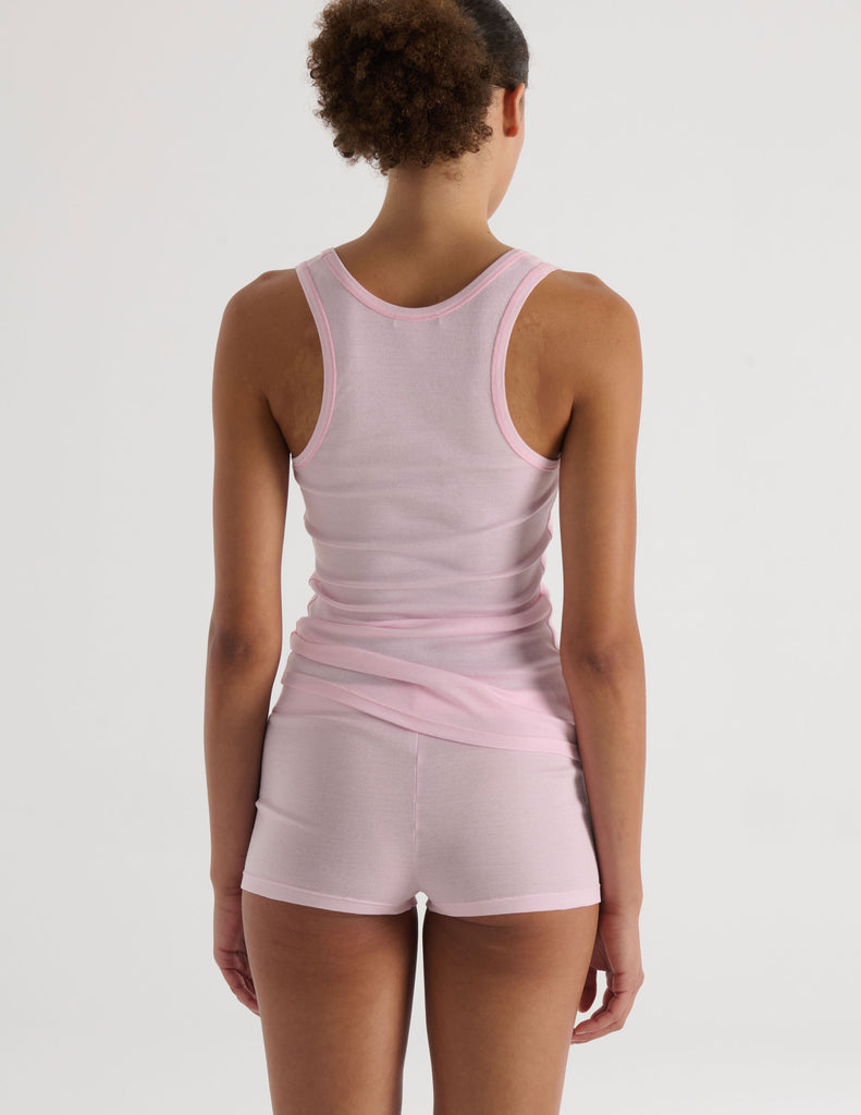 A model in the araks organic cotton james tank and presley short in confection pink