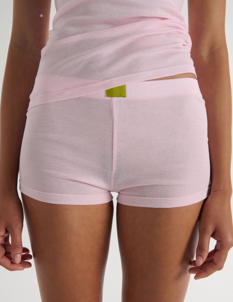 A model in the araks organic cotton james tank and presley short in confection pink