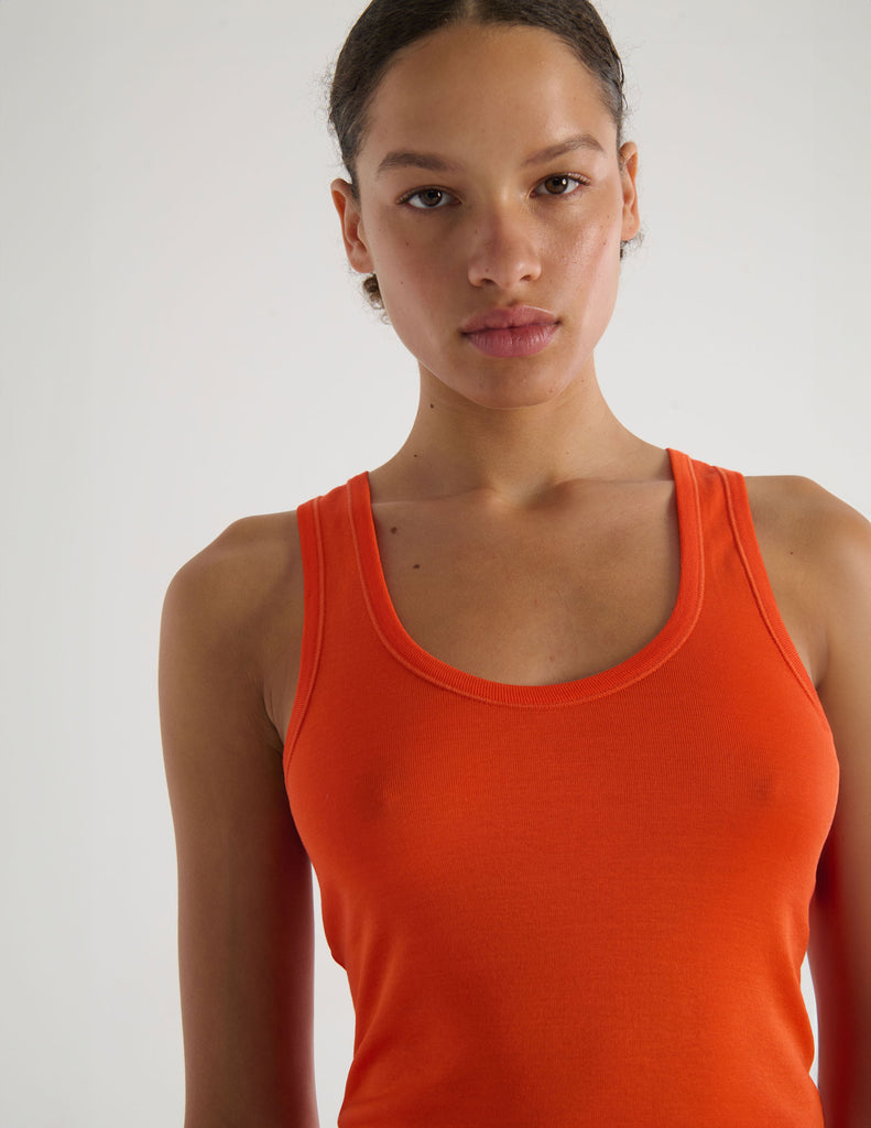 A model in the organic cotton james tank and presley short in marmalade orange