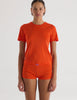 A model in the araks tavi short sleeve and presley short in organic cotton in marmalade orange