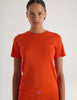 A model in the araks tavi short sleeve and presley short in organic cotton in marmalade orange