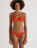A model in the araks organic cotton antonia bralette and isabella panty in marmalade