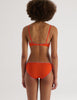 Back of Person wearing an Araks orange organic cotton Antonia Bralette and Isabella Panty set on a white background