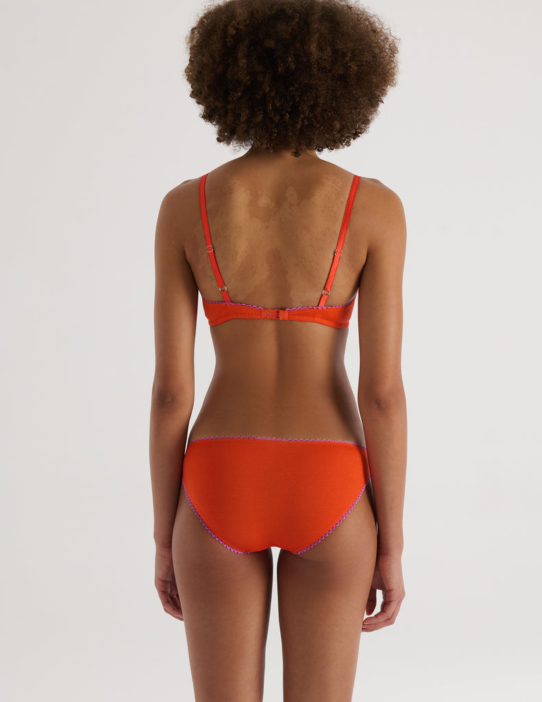 A model in the araks organic cotton antonia bralette and isabella panty in marmalade