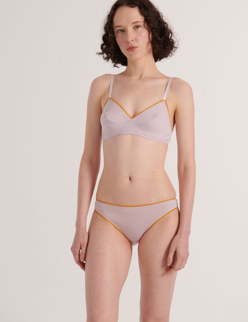 a model in the organic cotton antonia bralette and isabella panty in fairy lavender