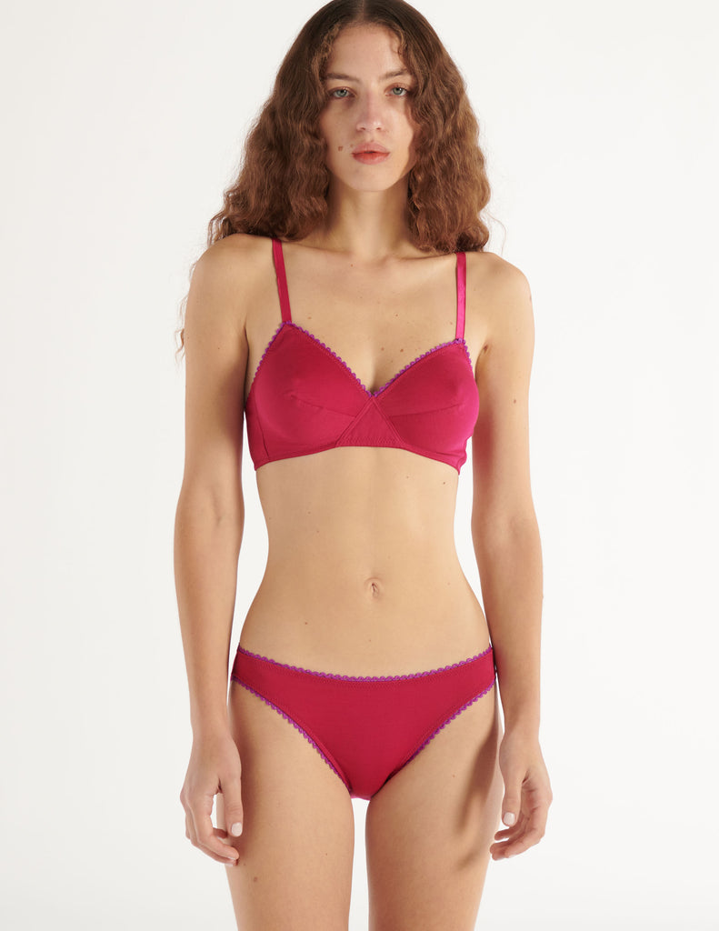 a model in the araks organic cotton antonia bralette and isabella panty in cherie pink