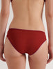 A model in the araks organic cotton isabella panty in clay red