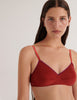 A model in the araks organic cotton antonia bralette in clay red