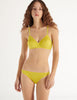 a model in the araks organic cotton antonia bralette and isabella panty in electric yellow
