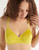 a model in the araks organic cotton antonia bralette in electric yellow