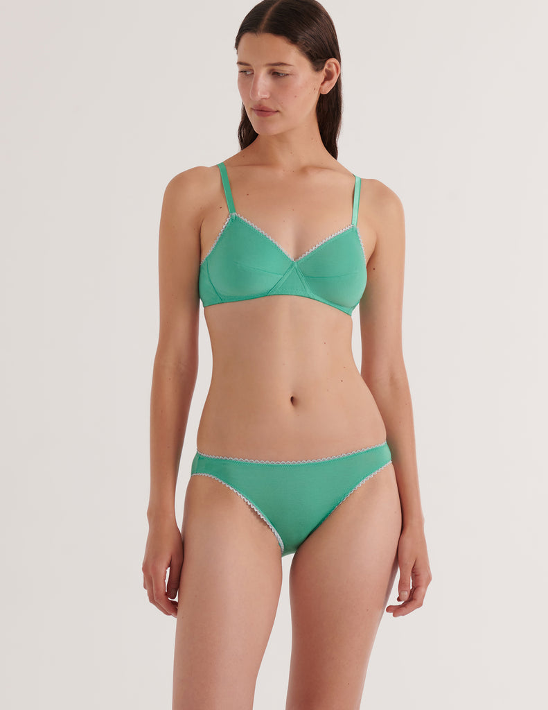 A model in the araks organic cotton antonia bralette and isabella panty in glass green