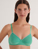 A model in the araks organic cotton antonia bralette in glass green