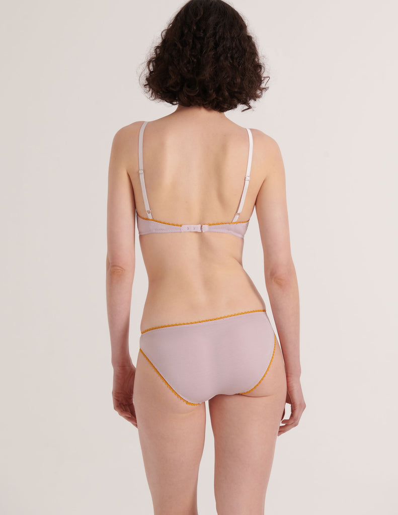 a model in the araks organic cotton antonia bralette and isabella panty in fairy lavender from the back