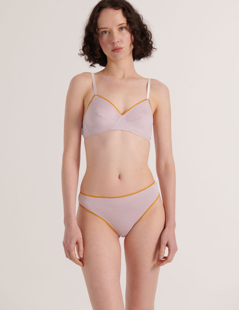 A model in the araks 100% organic cotton antonia bralette and stella thong in fairy lavender