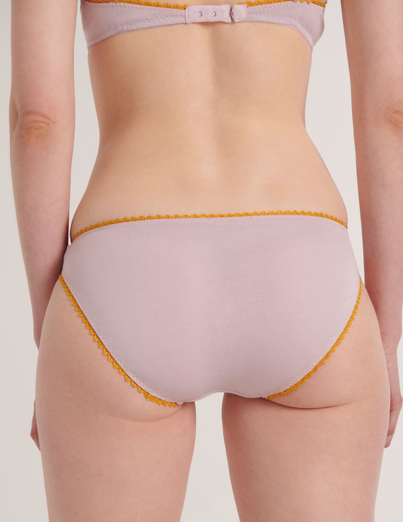 a close up of a model in the araks organic cotton isabella panty in fairy lavender