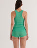A model in the Araks organic cotton james tank top and presley short in glass green
