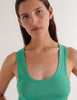 A model in the araks organic cotton james tank top in glass green