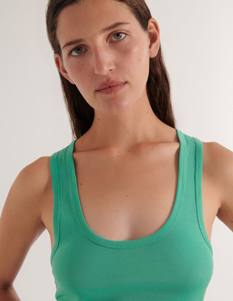A model in the araks organic cotton james tank top in glass green