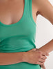 A model in the araks organic cotton james tank top in glass green