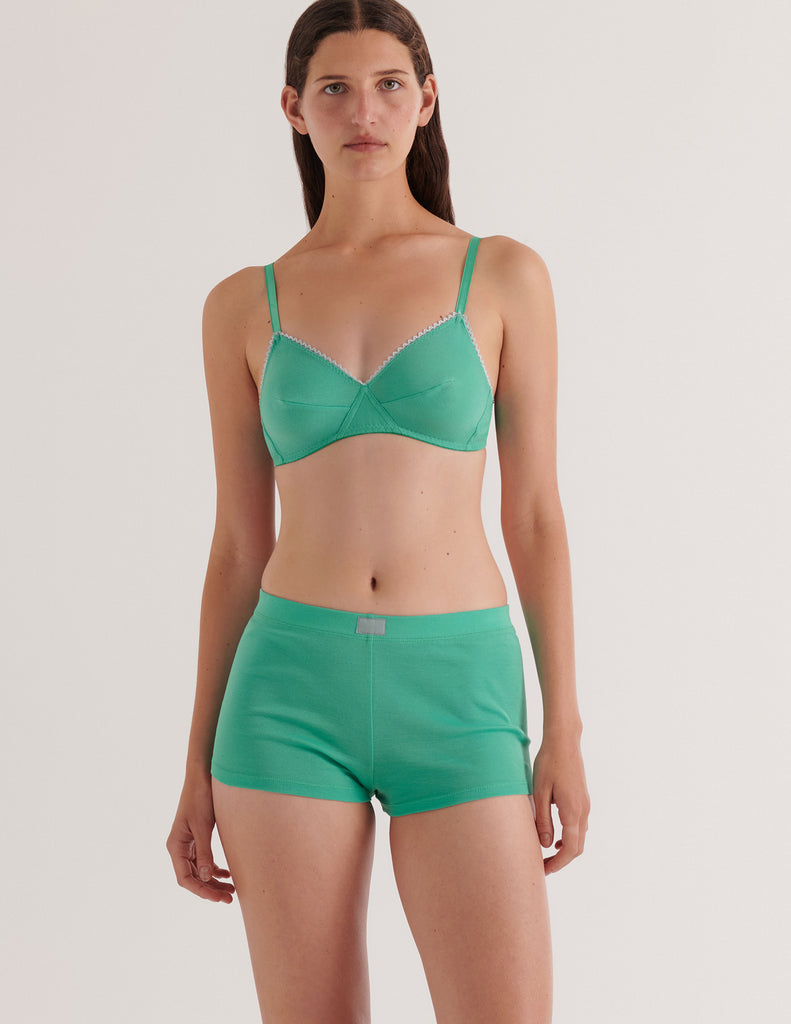 A model in the araks organic cotton antonia bralette and presley short in glass green