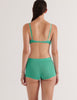A model in the araks organic cotton antonia bralette and presley short in glass green