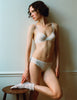 A model wearing the araks organic cotton Sofia Underwire Bra and the Isabella Panty in white cotton. 