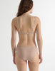 Back view image of model wearing araks sand colored organic cotton sofia underwire bra with matching hipster. 