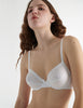 Detail view image of model wearing araks organic cotton white sofia underwire bra with white trim.  