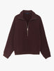 A flat lay image of the Araks Vivienne zip-up in the shade Mill, against a solid white background.