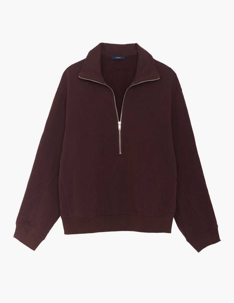 A flat lay image of the Araks Vivienne zip-up in the shade Mill, against a solid white background.