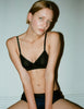 A model wearing the Antonia bralette in black organic cotton