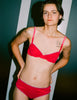 a model wearing the araks organic cotton sofia underwire bra and josephine hipster in bright pink cotton