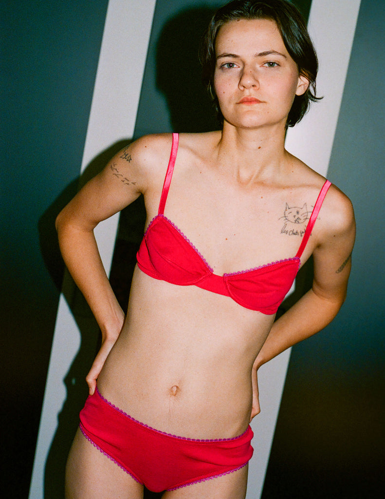a model wearing the araks organic cotton sofia underwire bra and josephine hipster in bright pink cotton