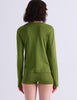 A model shown from the back wearing the Sabine long sleeve top and Presley short against a light gray studio background.