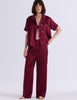Model wearing Araks Shelby silk pajama top with the Viktoria pajama bottoms in Garnet