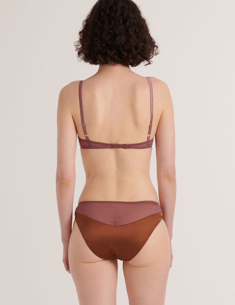 A model from the back in the silk beatrice bralette and aaron panty in noisette brown