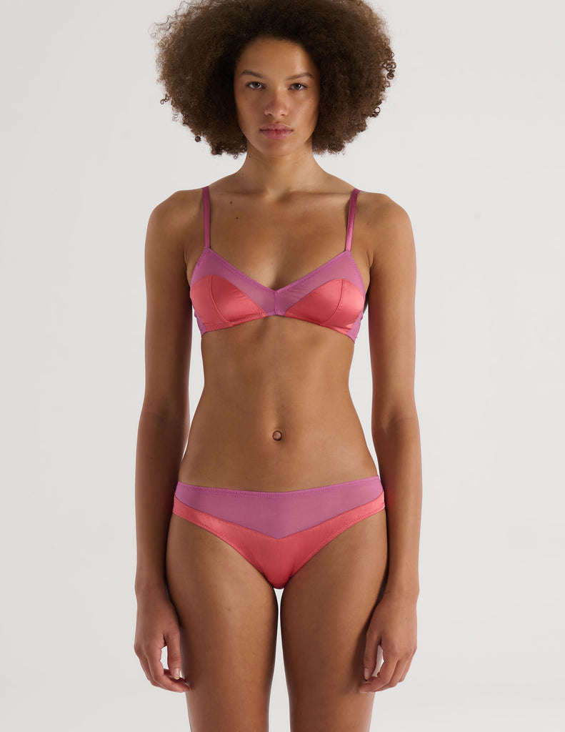 A model in the araks silk charmeuse and silk chiffon beatrice bralette and aaron panty in tart pink