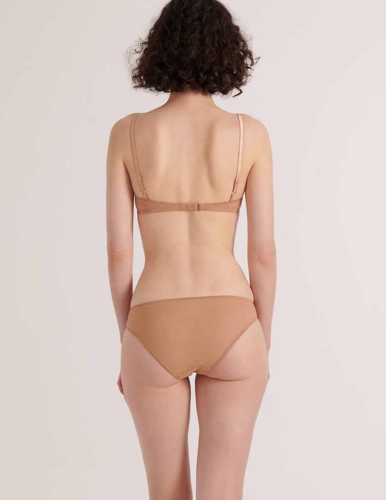 A model in the araks cotton and silk uma bralette and harriet panty in brulee brown