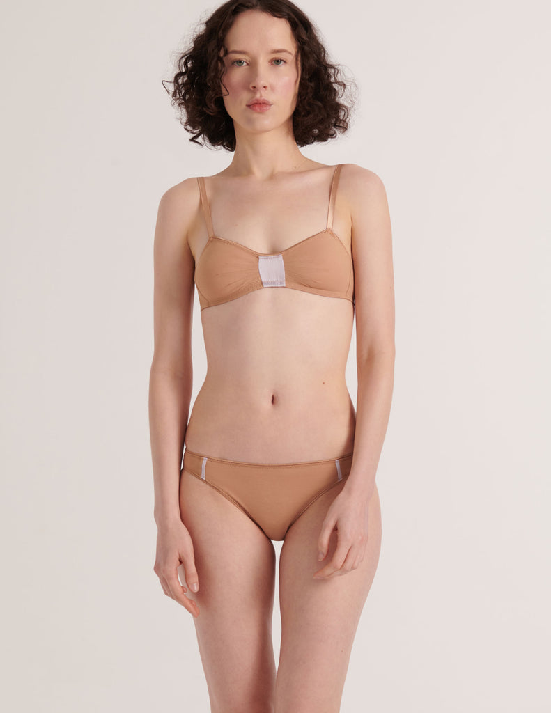 A model in the araks cotton and silk uma bralette and harriet panty in brulee brown