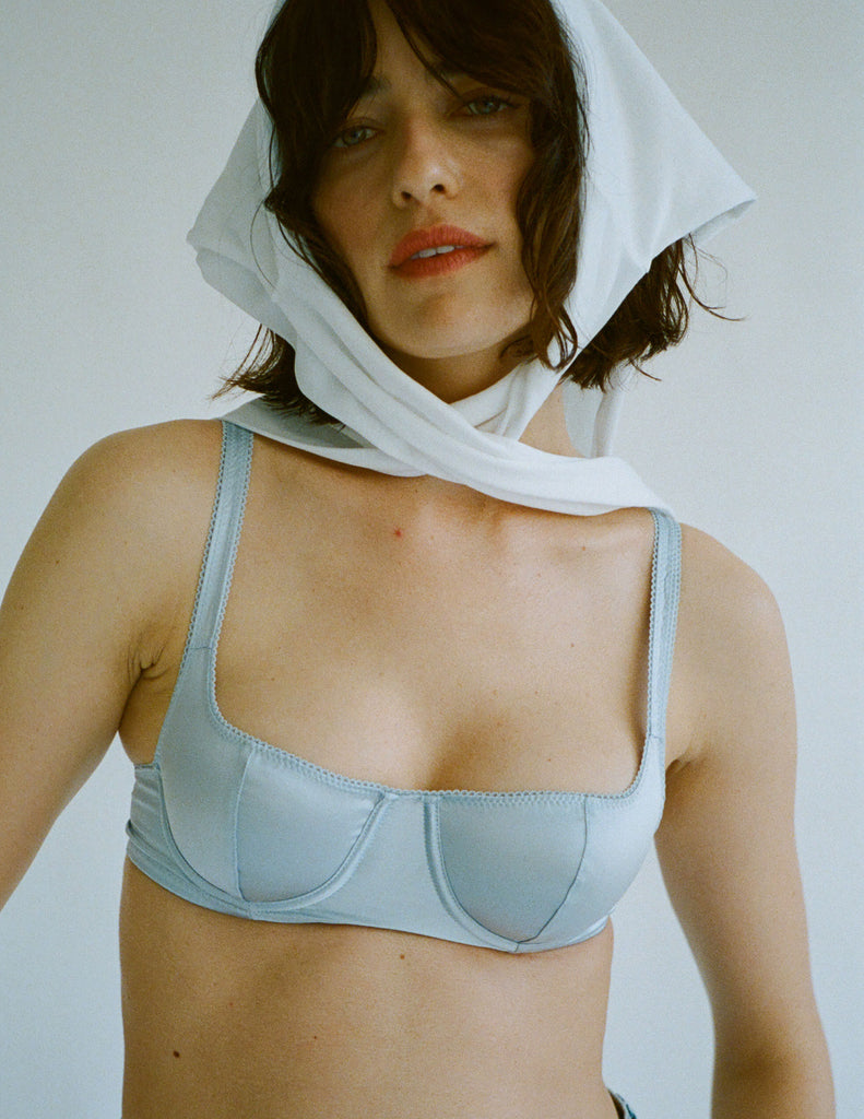 A model in the araks silk gita underwire bra in glace blue