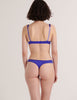 A model in the araks silk charmeuse gita underwire bra and grier thong in tanzanite blue