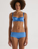 a model in the araks silk charmeuse gita underwire bra and gal hipster in bluet blue