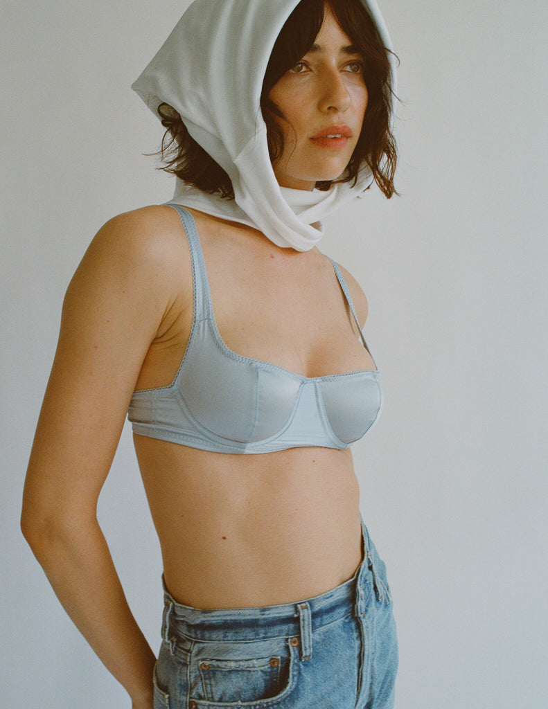 A model in the araks silk gita underwire bra in glace blue