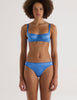 A model in the araks silk charmeuse gita underwire bra and grier thong in bluet blue