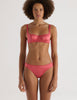 A model in the araks silk gita underwire bra and grier thong in rose pink